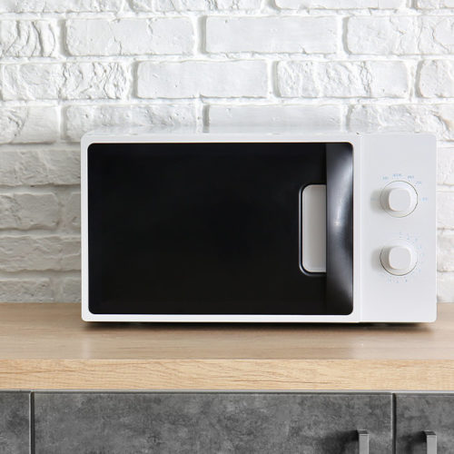 close-up-of-a-white-microwave-sitting-on-top-of-a-wooden-table-fort-collins-co