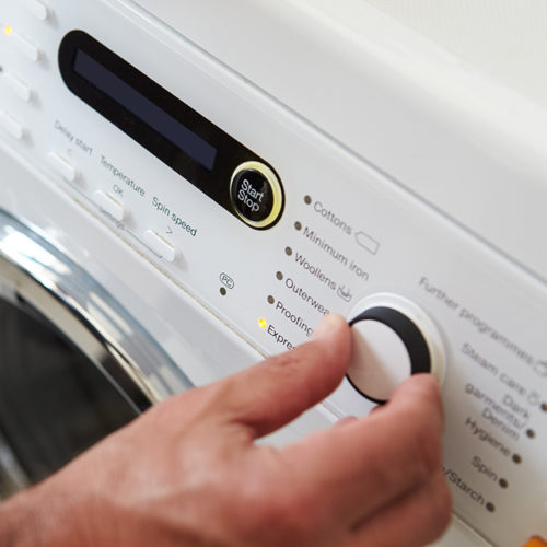 man-hand-close-up-setting-up-washing-machine-fort-collins-co