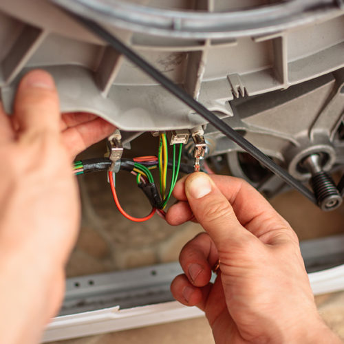 technician-hands-close-up-repairing-dryer-machine-wires-fort-collins-co