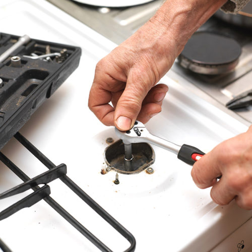 technician-hands-close-up-with-tools-repairing-stove-burner-fort-collins-co