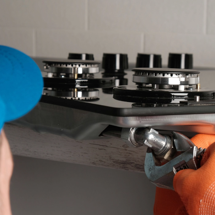 technician fixing a cooktop greeley co
